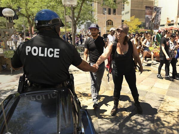 Photo of Police Officer Shaking Hands with Person. 