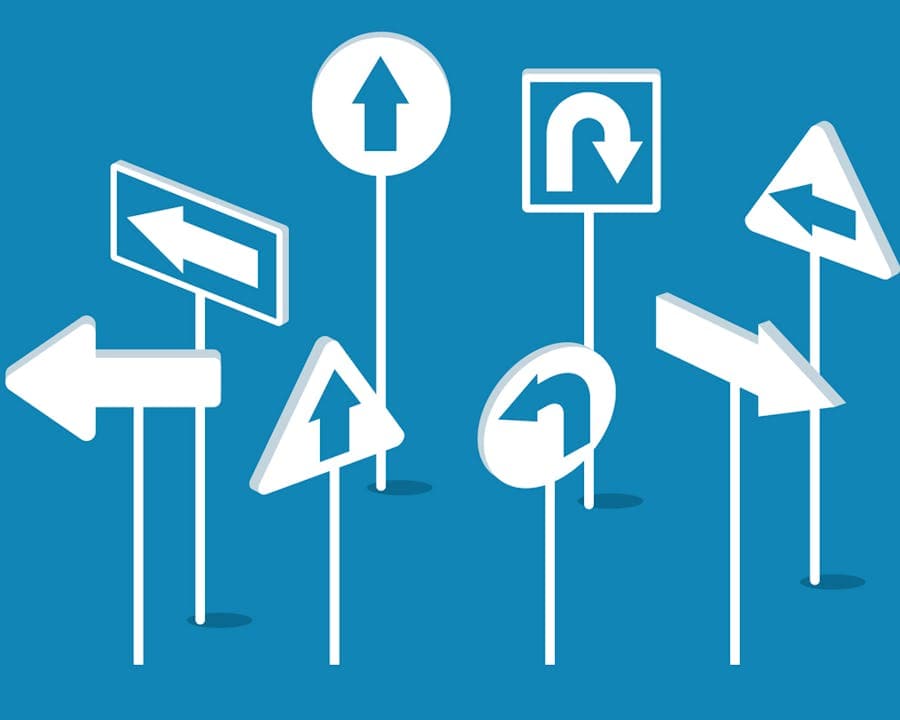 Image of road signs pointing in different directions. 
